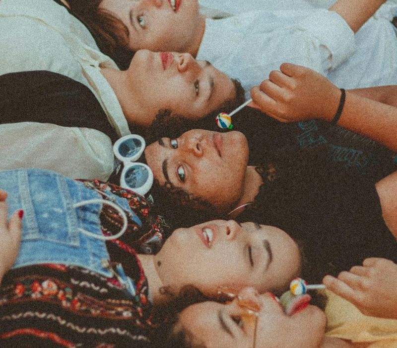 Diverse group of people smiling and looking energetic, with an amber color theme.