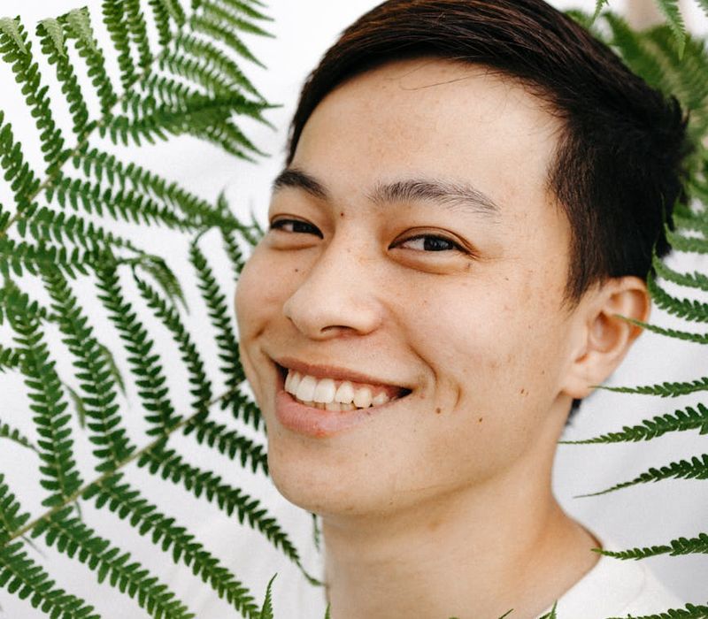 Person feeling refreshed and serene in a natural, bright environment with grey accents.
